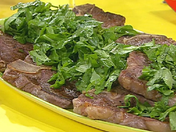 T-bone steaks with chopped green garni, broiled tomatoes with cheese, olives and herbs recipe