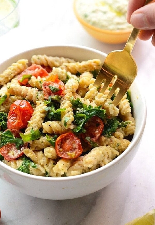 Creamy cashew pasta with tomatoes and kale