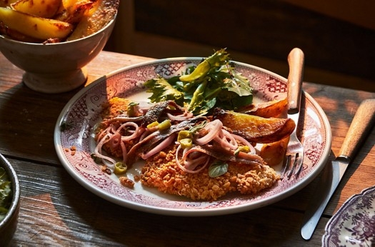 Pork schnitzels with pickled shallots, chillies, anchovies & potato wedges