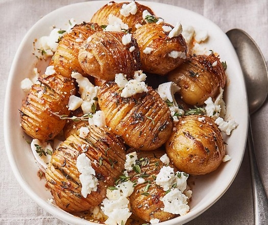 Hasselback new potatoes with hot honey & goat's cheese