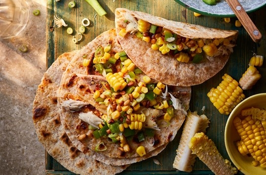Corn, pine nut & salad onion stir fry with hot smoked mackerel in piadina flatbreads