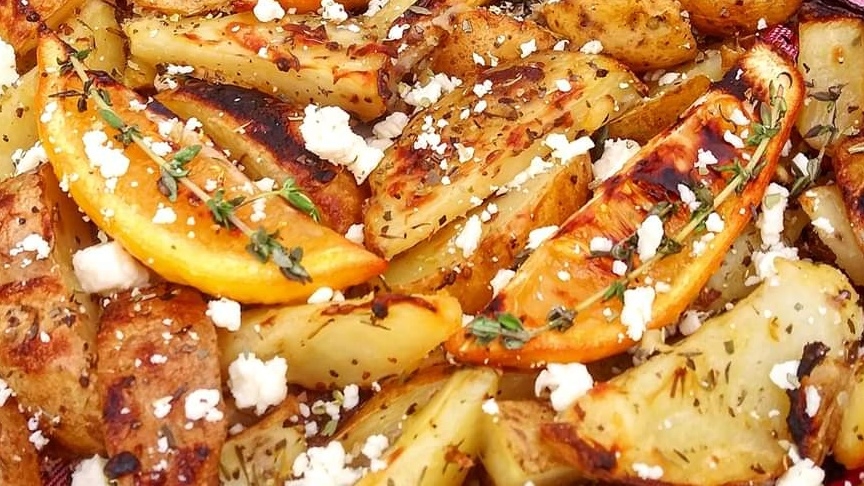 Oven-roasted greek potatoes with roasted lemon wedges