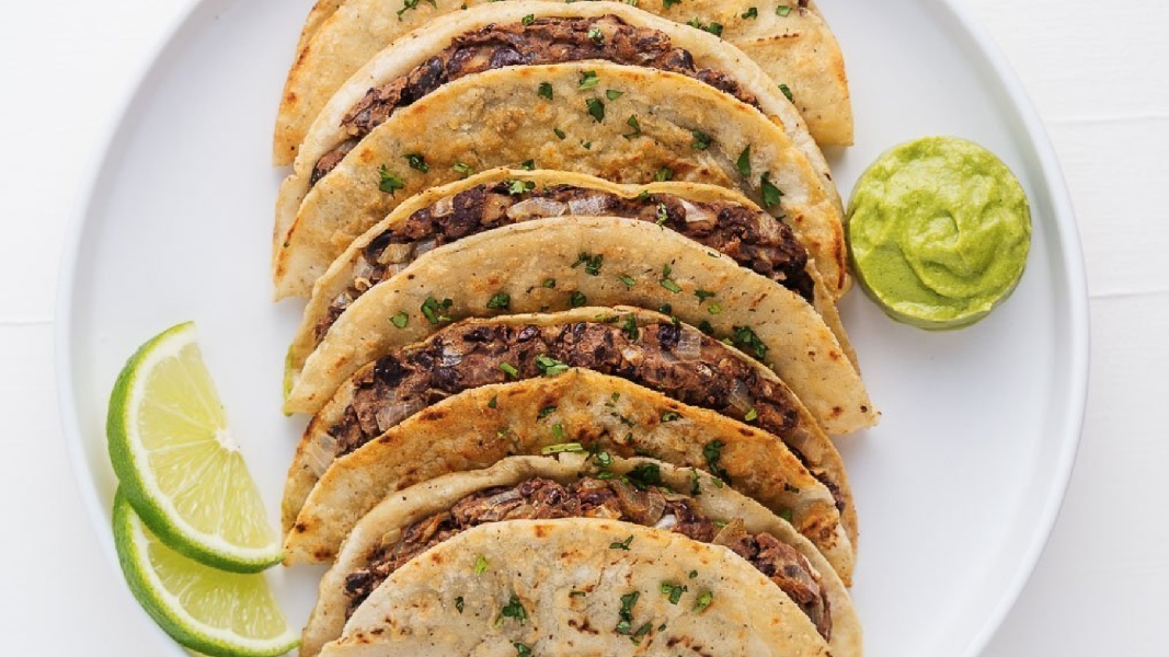 Crispy black bean tacos with avocado cream sauce
