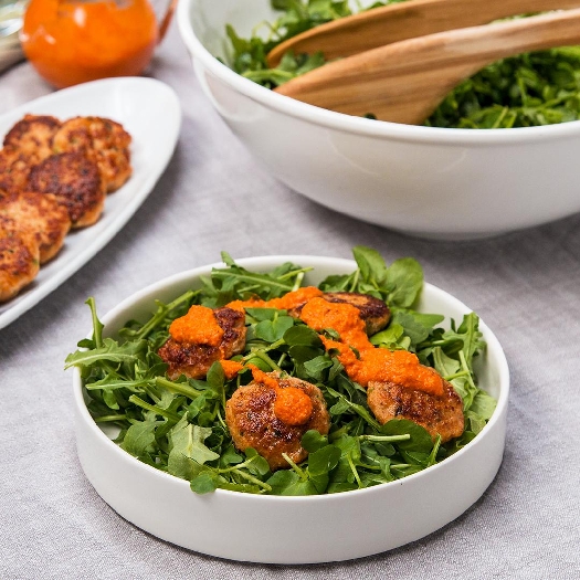 Pan-fried shrimp cakes with arugula and watercress salad
