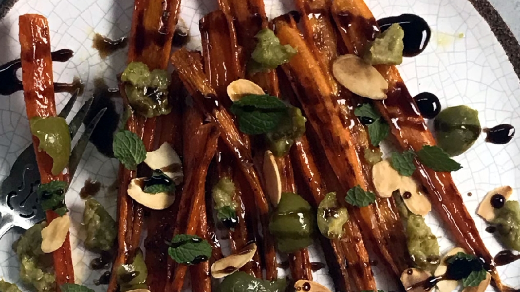 Easy, maple roasted carrots with olives + almonds + mint