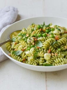 Pesto pasta salad with peas, pine nuts & mozzarella pearls