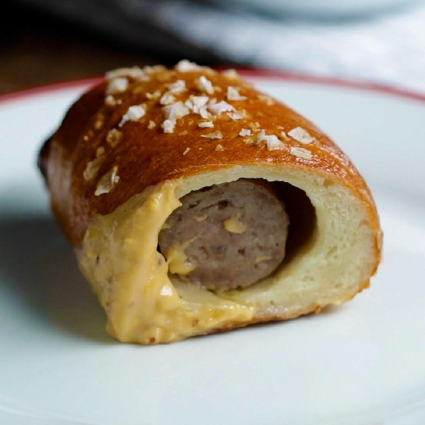 Brats in a blanket with beer mustard cheese sauce